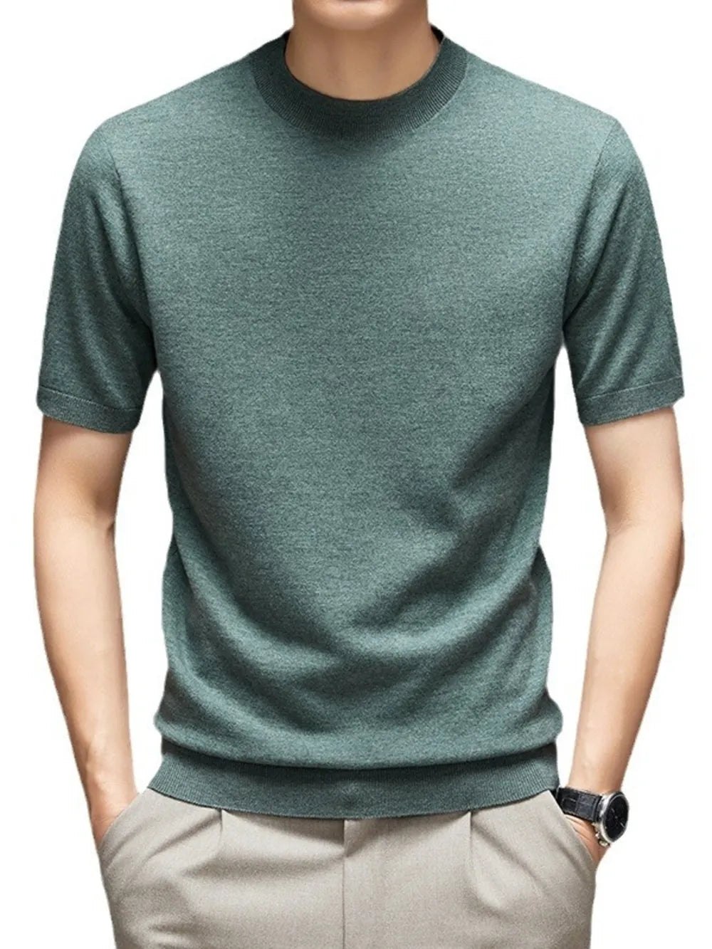 Green t-shirt worn by a person on a white background