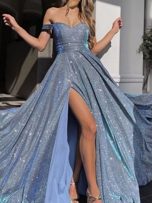 Blue sparkly evening gown with a high slit on a neutral background