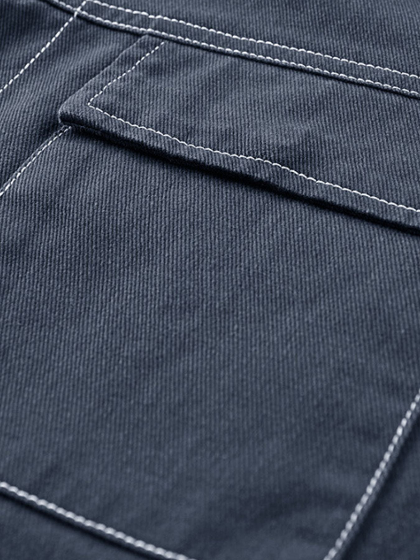 Close-up of dark blue fabric with white stitching
